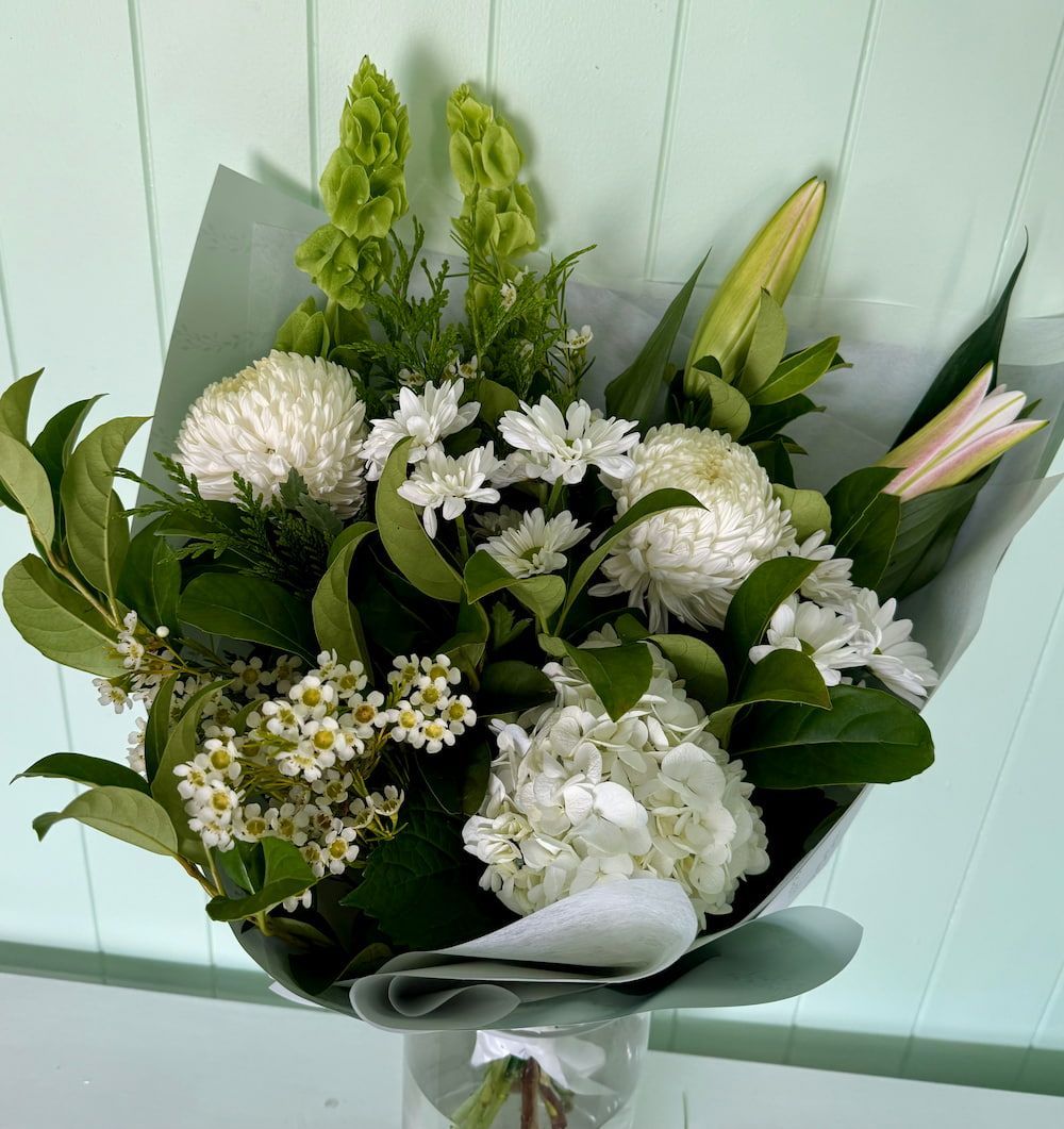 A Close Up Of A Bouquet Of Flowers On A Table — Ivy & Ash Flowers & Gifts in Palmview, QLD