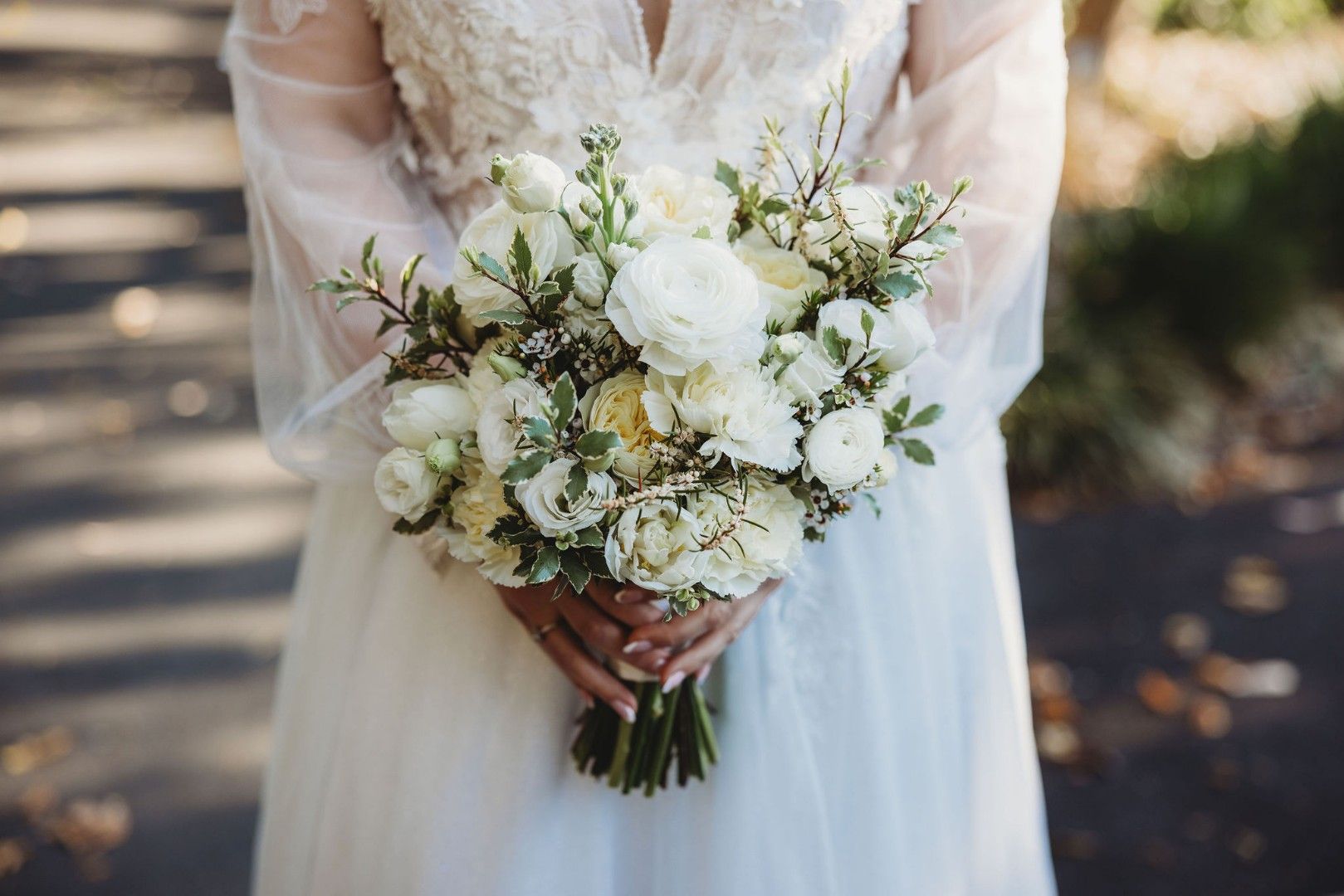 A Bride In A White Dress Is Holding A Bouquet Of Pink And White Flowers — Ivy & Ash Flowers & Gifts in Palmview, QLD