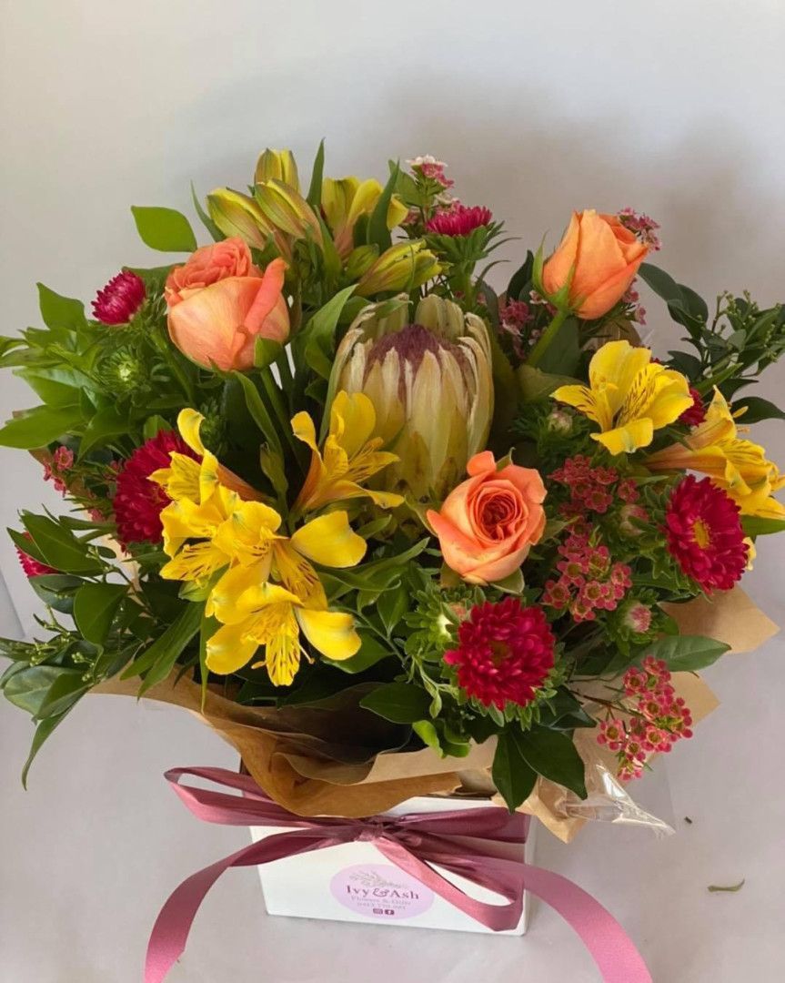 A Close Up Of A Bouquet Of Flowers On A Table Native Flower Bunch — Ivy & Ash Flowers & Gifts in Palmview, QLD