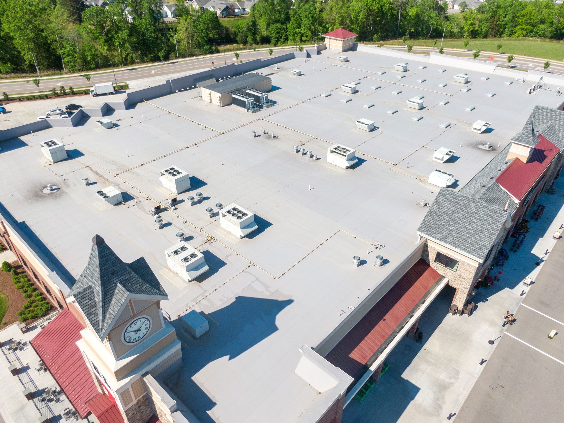 An aerial view of a large building with a clock tower on top of it.