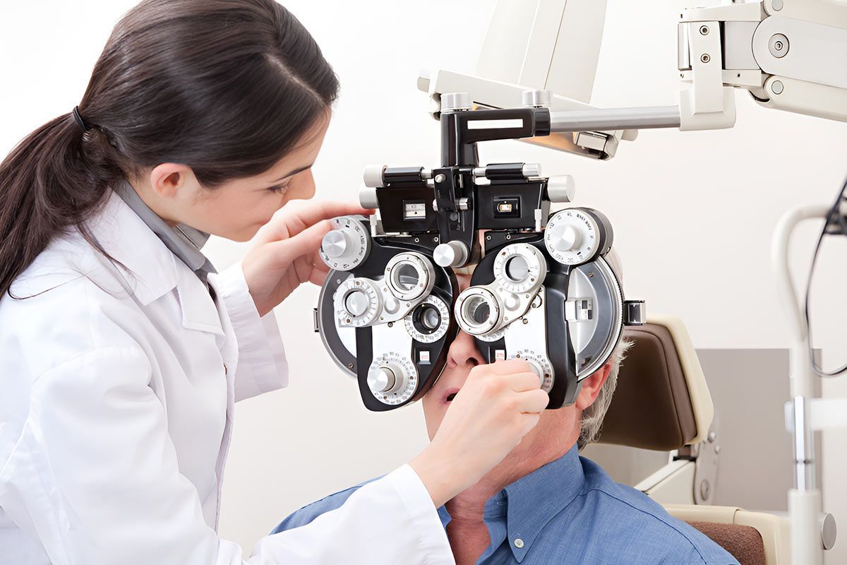 A Woman is Examining a Man's Eyes With a Machine — Eyedentity Optical in Earlville, QLD