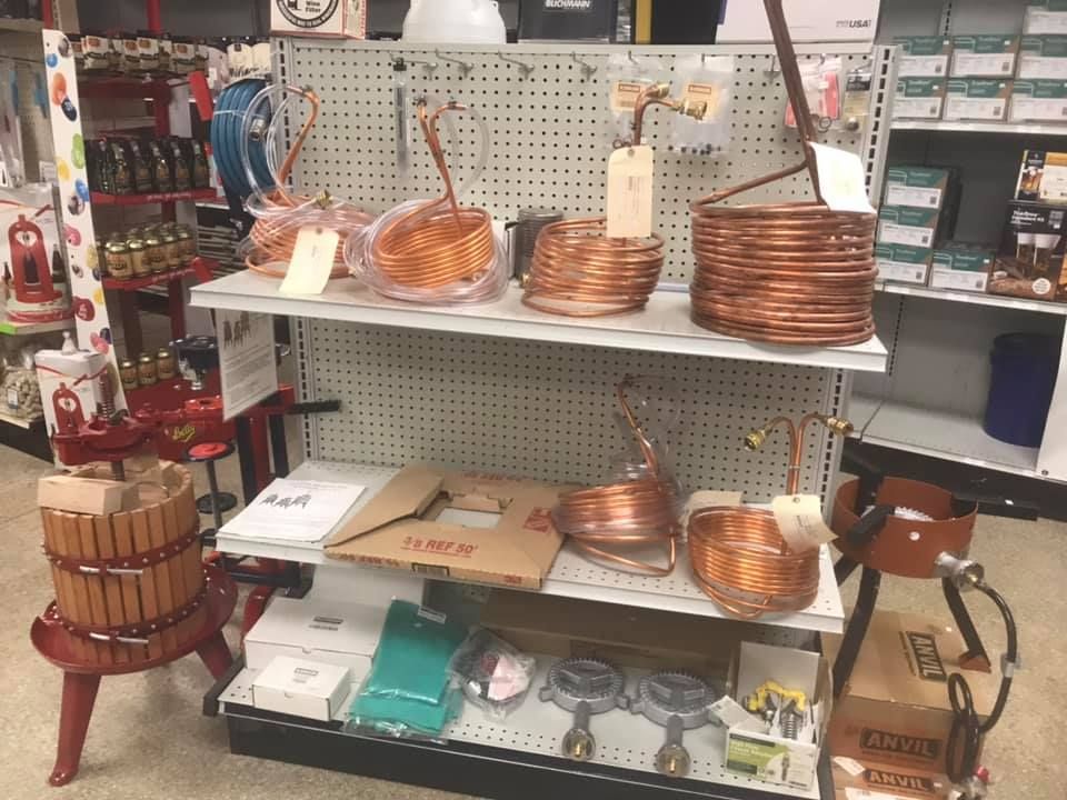 A shelf in a store with copper baskets on it