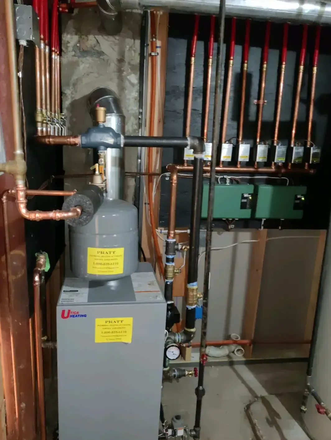 A gray boiler with a yellow sticker on it