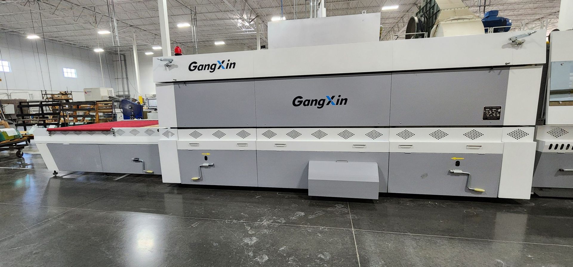 A large machine is sitting on a concrete floor in a factory.