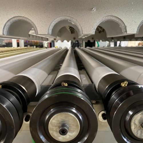 A bunch of metal pipes are lined up in a row