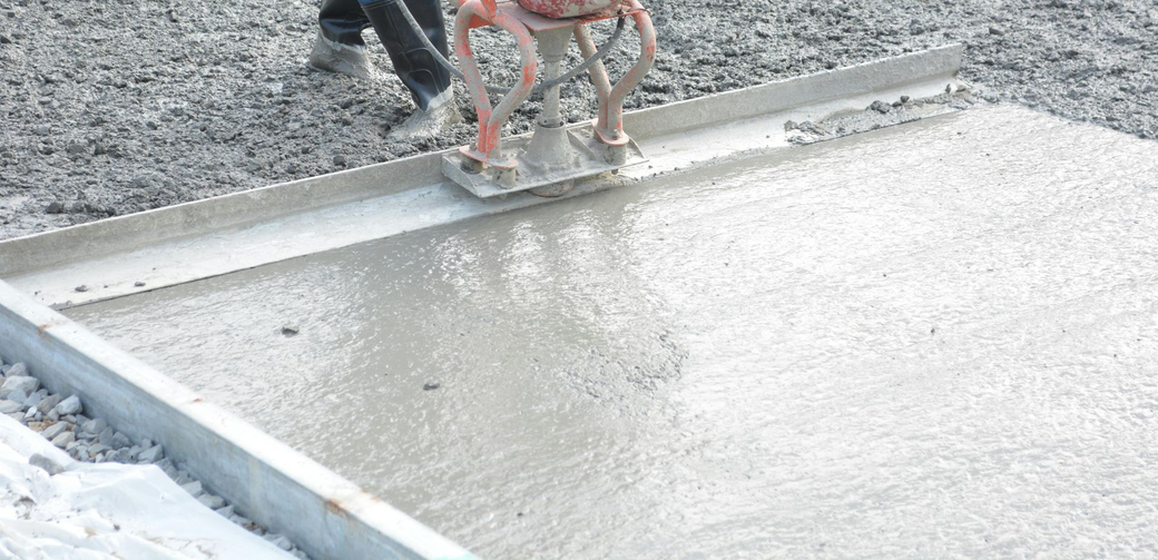 Person pressure washing a concrete porch.