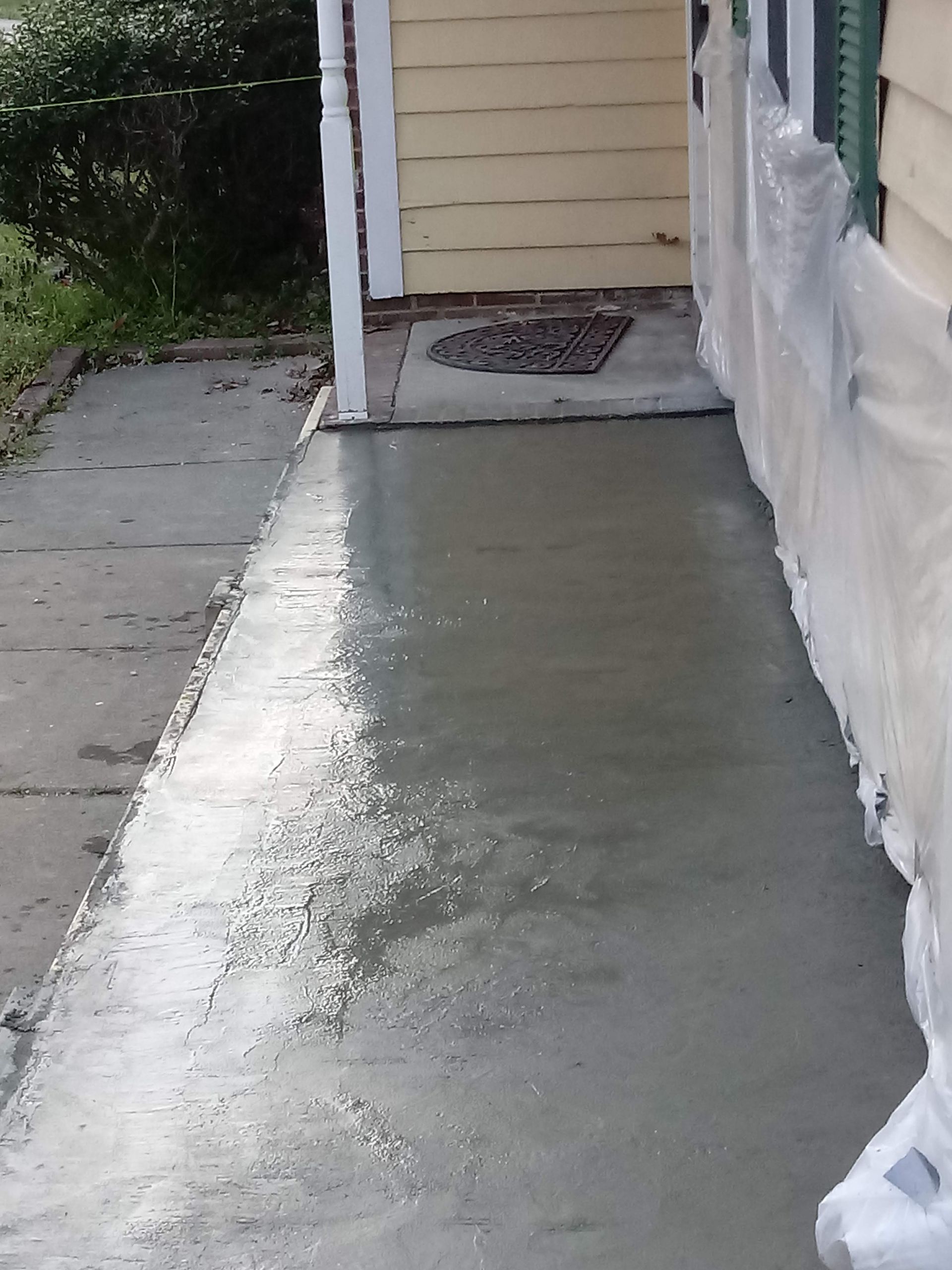 A living room in a house under construction with a fireplace and lots of windows.