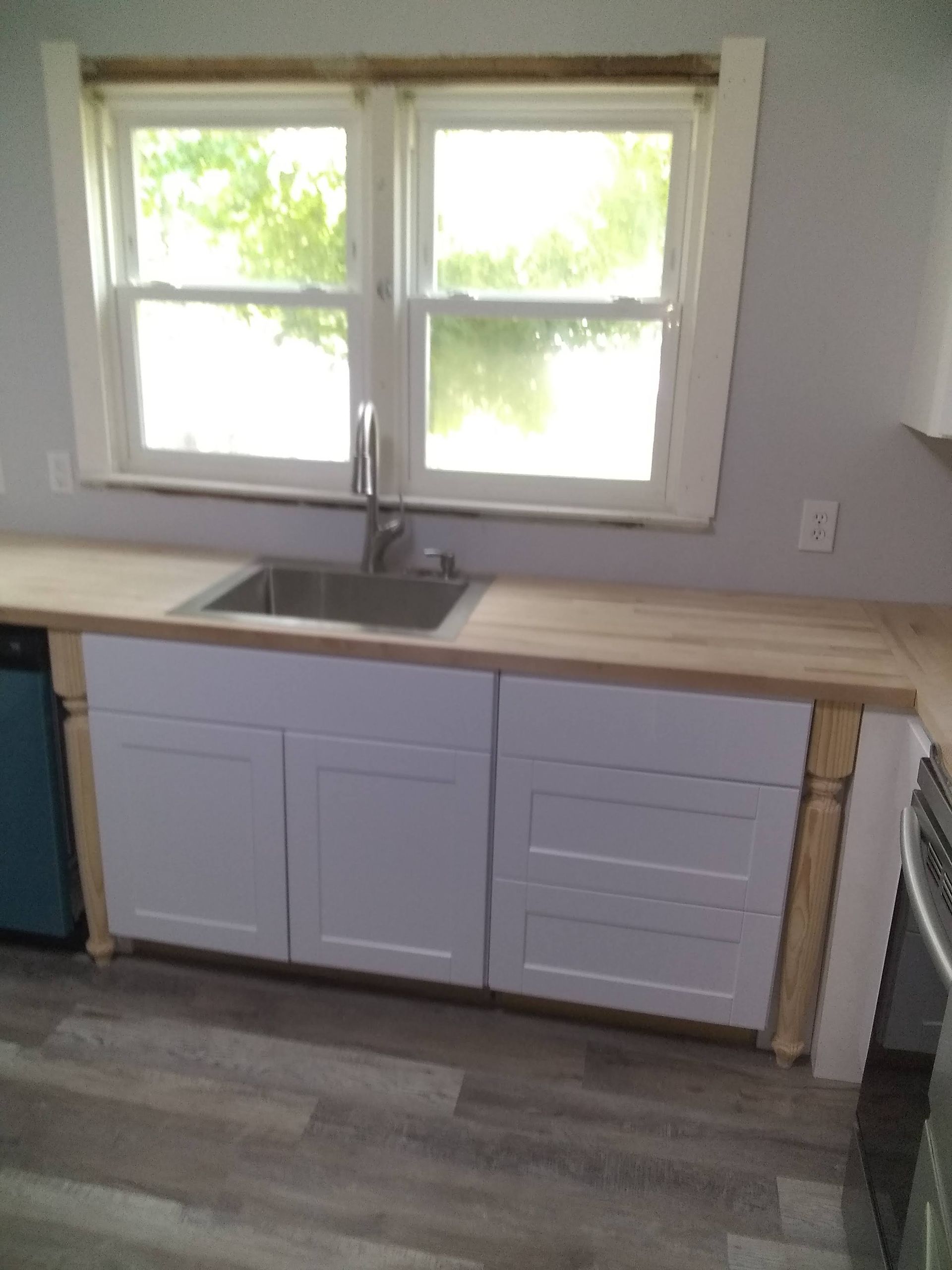A kitchen with stainless steel appliances and a marble counter top.