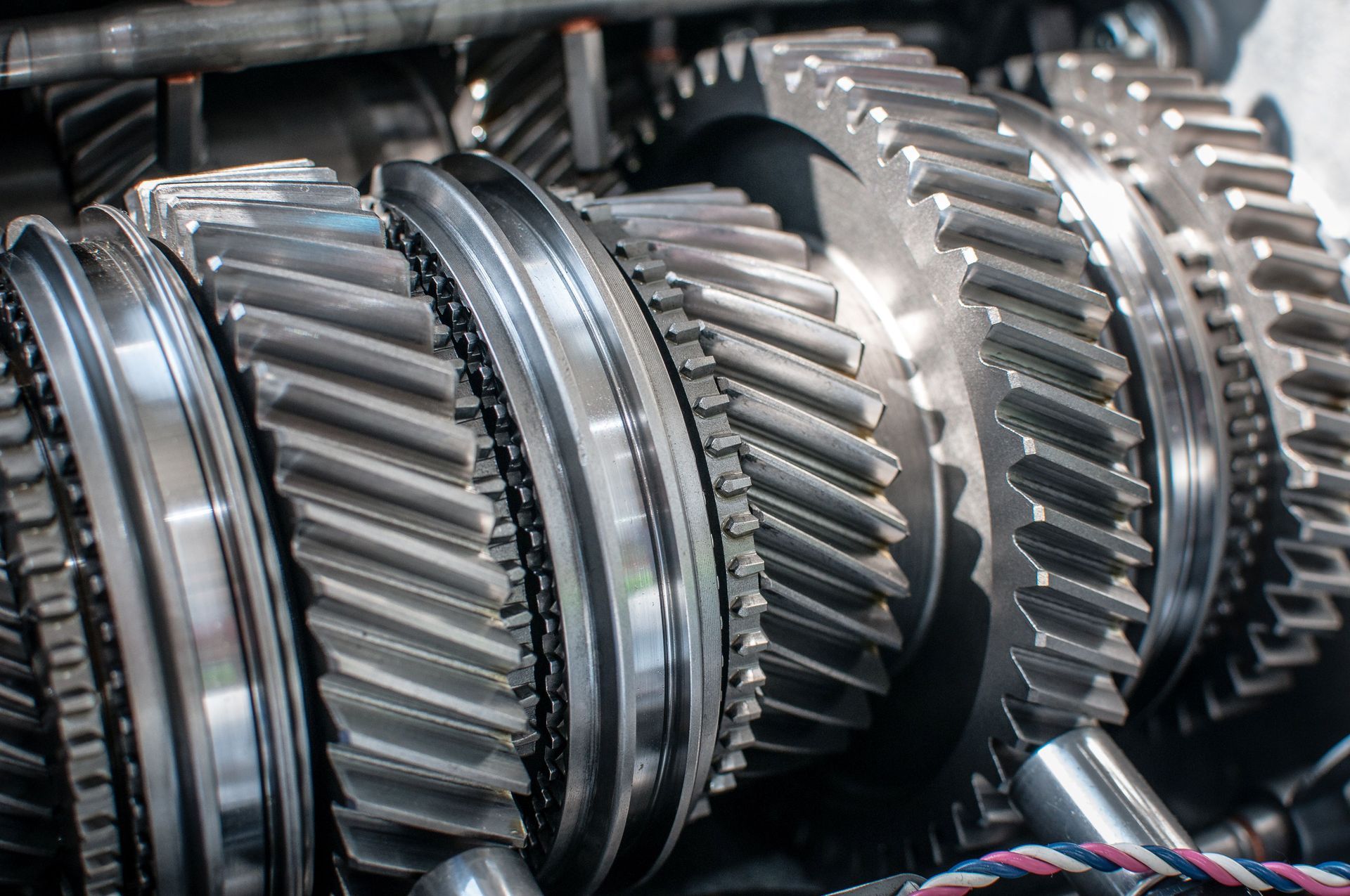 Close-up of shiny, interconnected gears inside a mechanical device, likely a transmission.