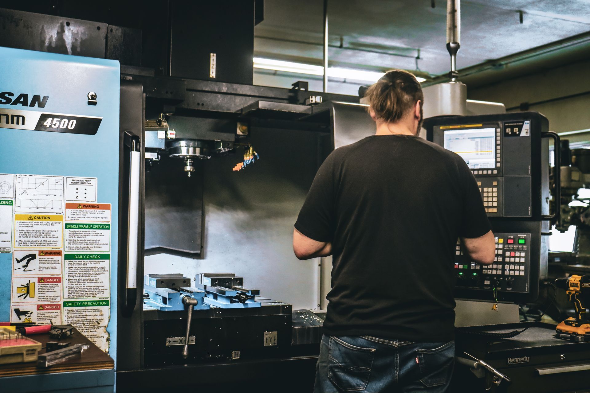 A man is working on a machine in a factory.