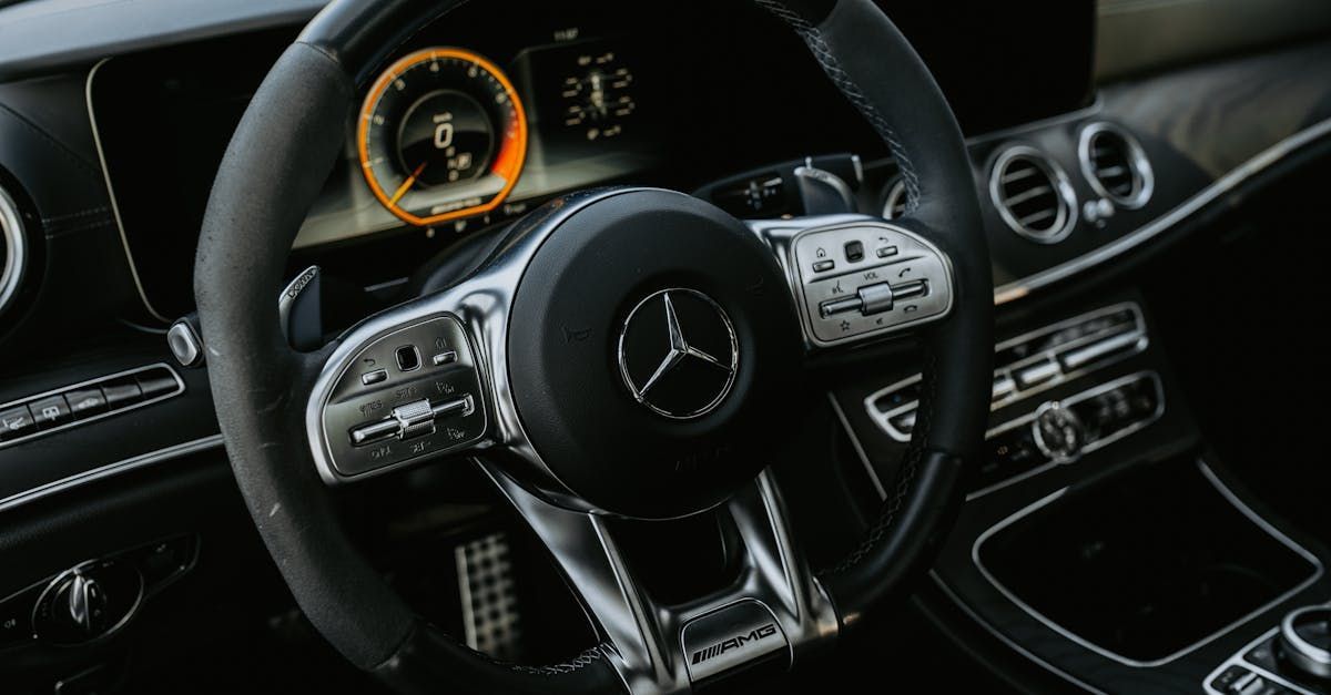A close up of a mercedes benz steering wheel and dashboard. | 299 Automotive