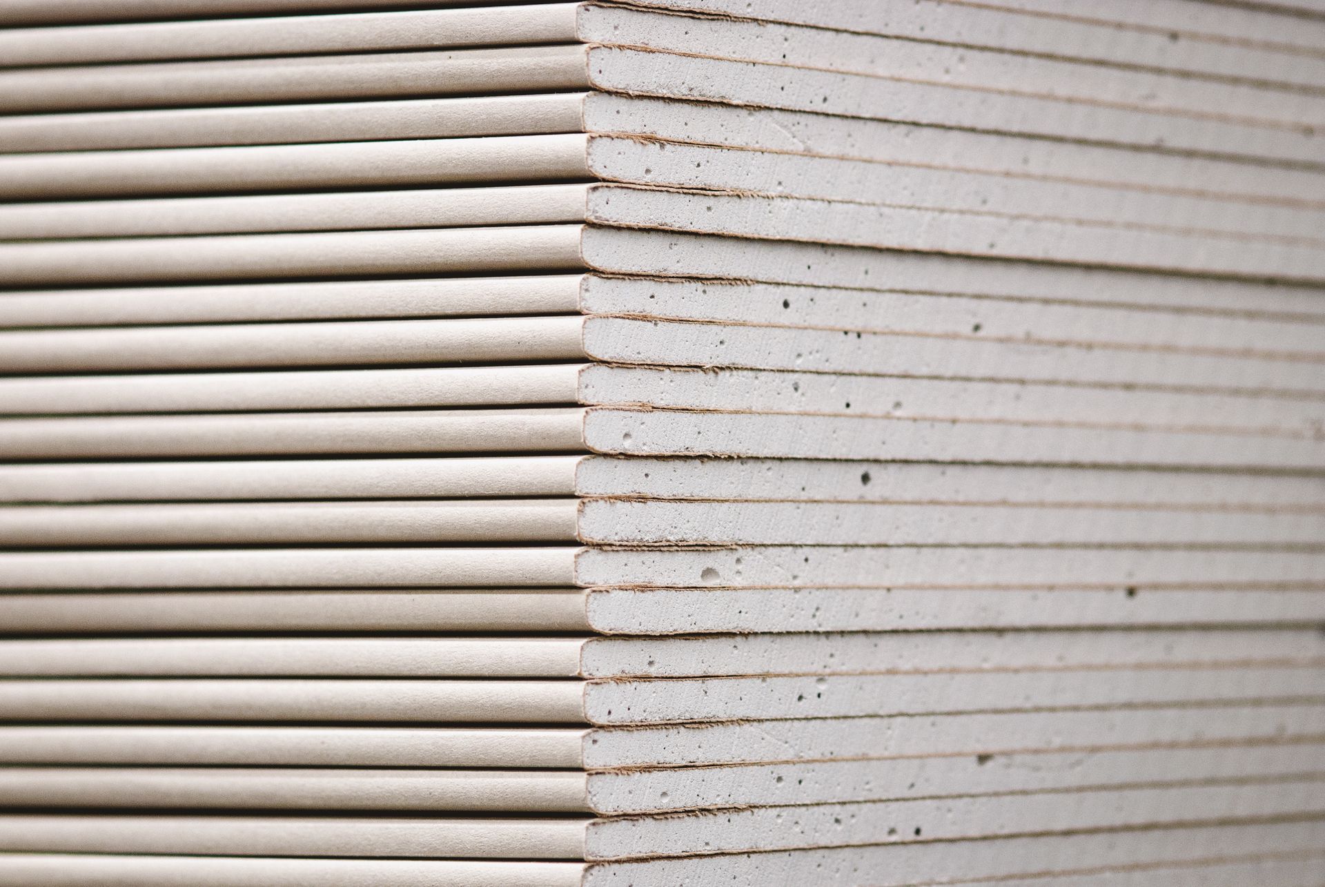 Gyprock standard panels, wallboards, and plasterboard stacked in a hardware store close-up.