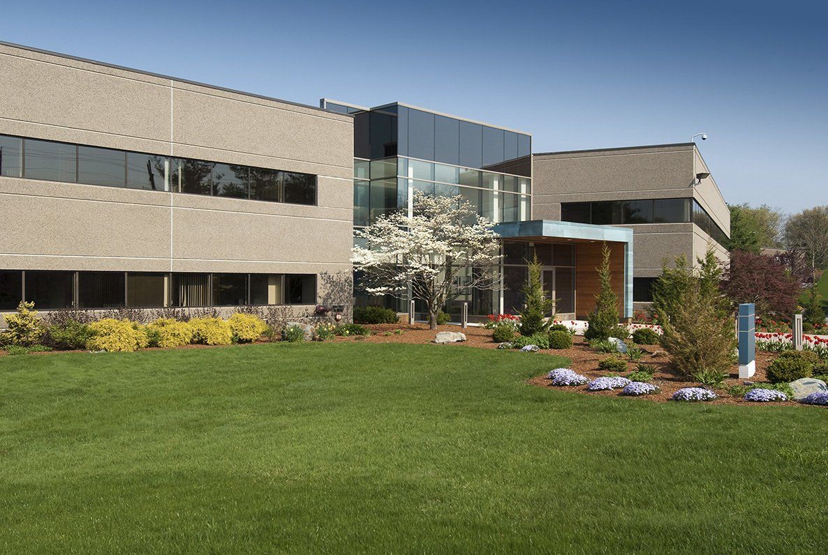 A large building with a lush green lawn in front of it