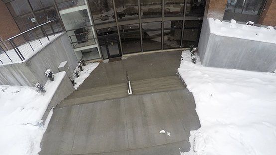An aerial view of a building with snow on the ground.