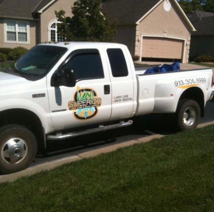 A white truck is parked in front of a house