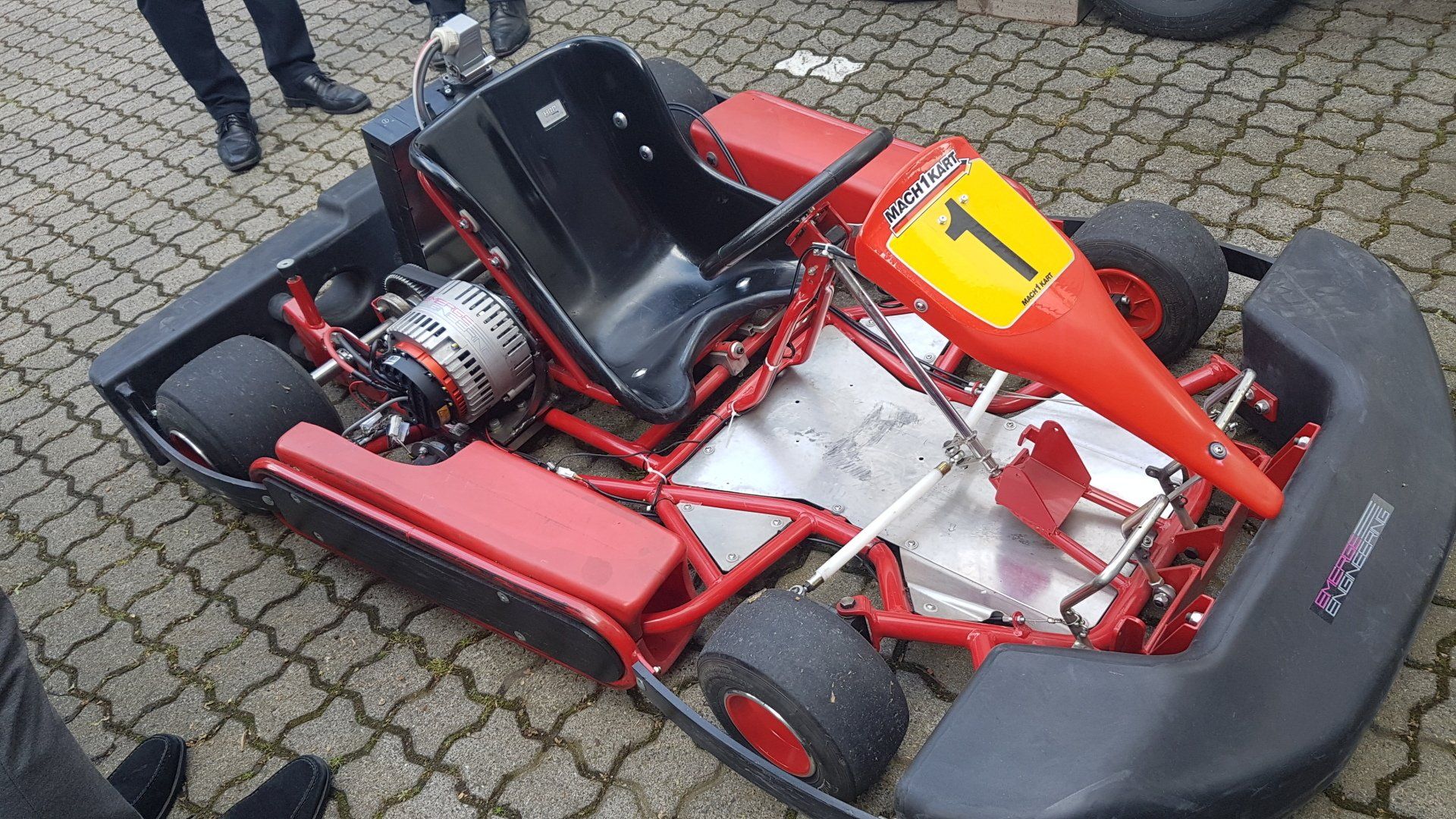 A red and black go kart with the number 1 on it
