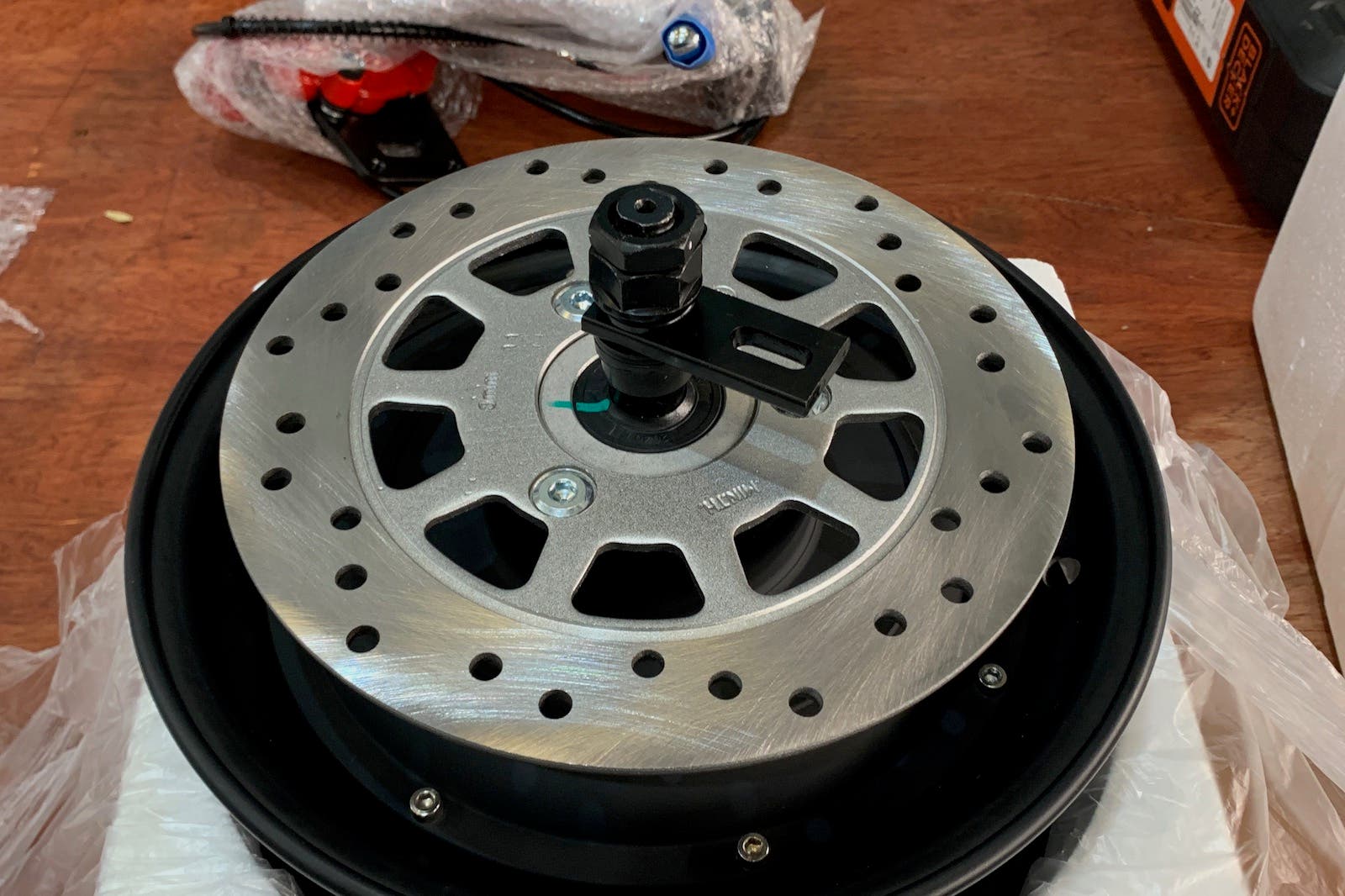 A close up of a brake disc on a wheel on a table.