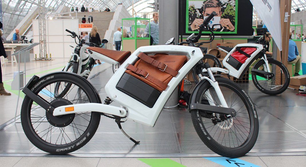 A white bicycle with a brown bag on the back of it