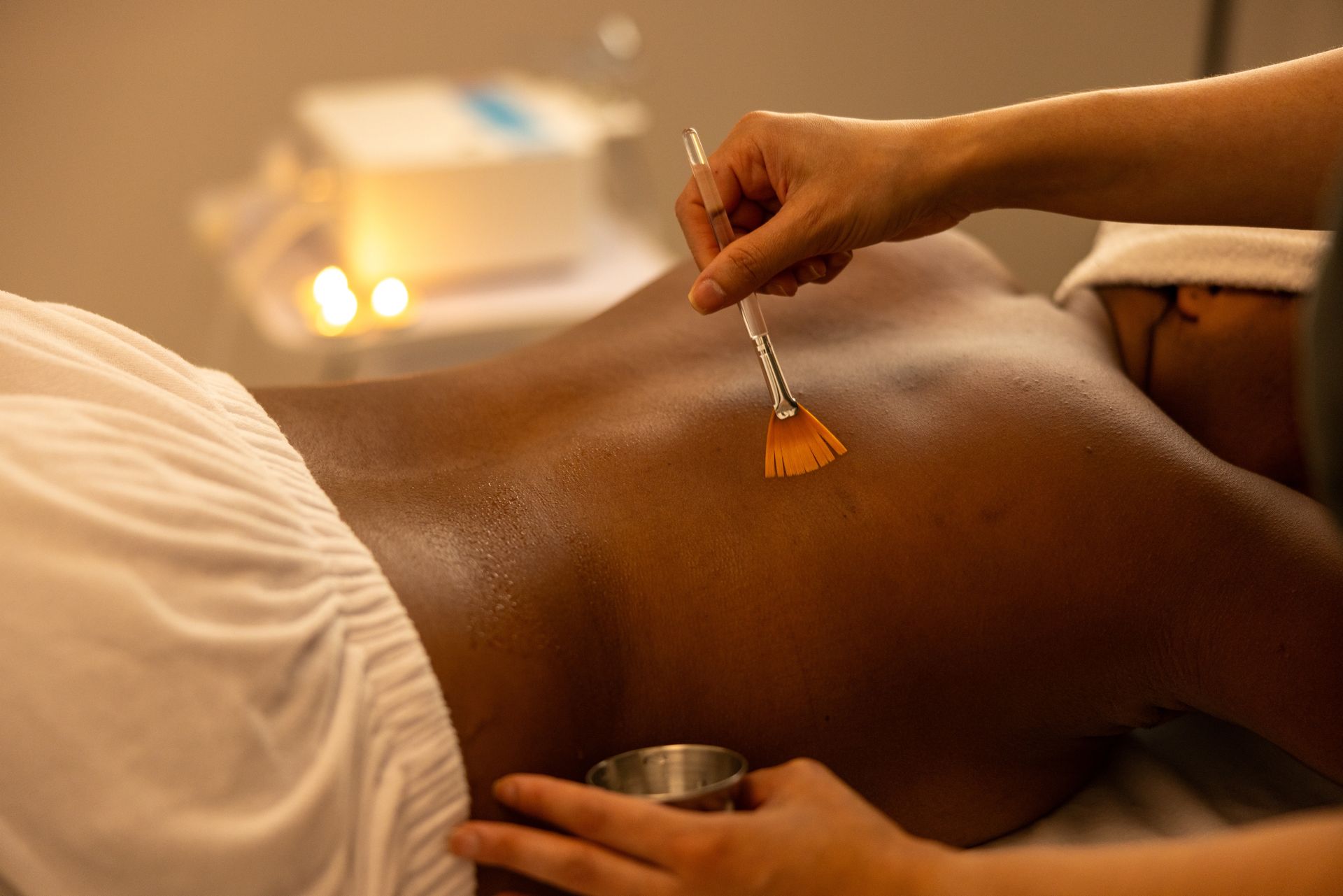 A woman is giving a man a massage in a spa.