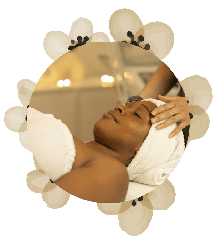 A woman is getting a massage with a towel around her head