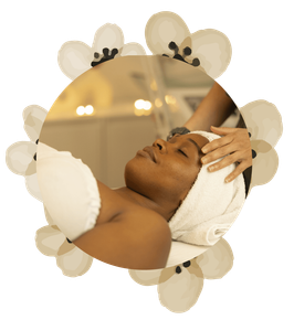 A woman is getting a massage with a towel around her head