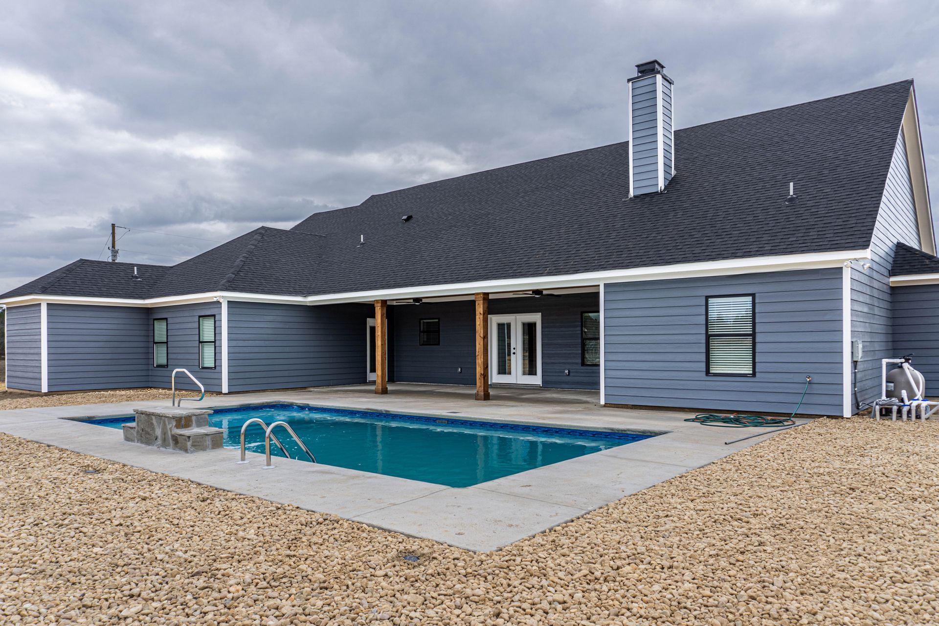 A large house with a large swimming pool in front of it.