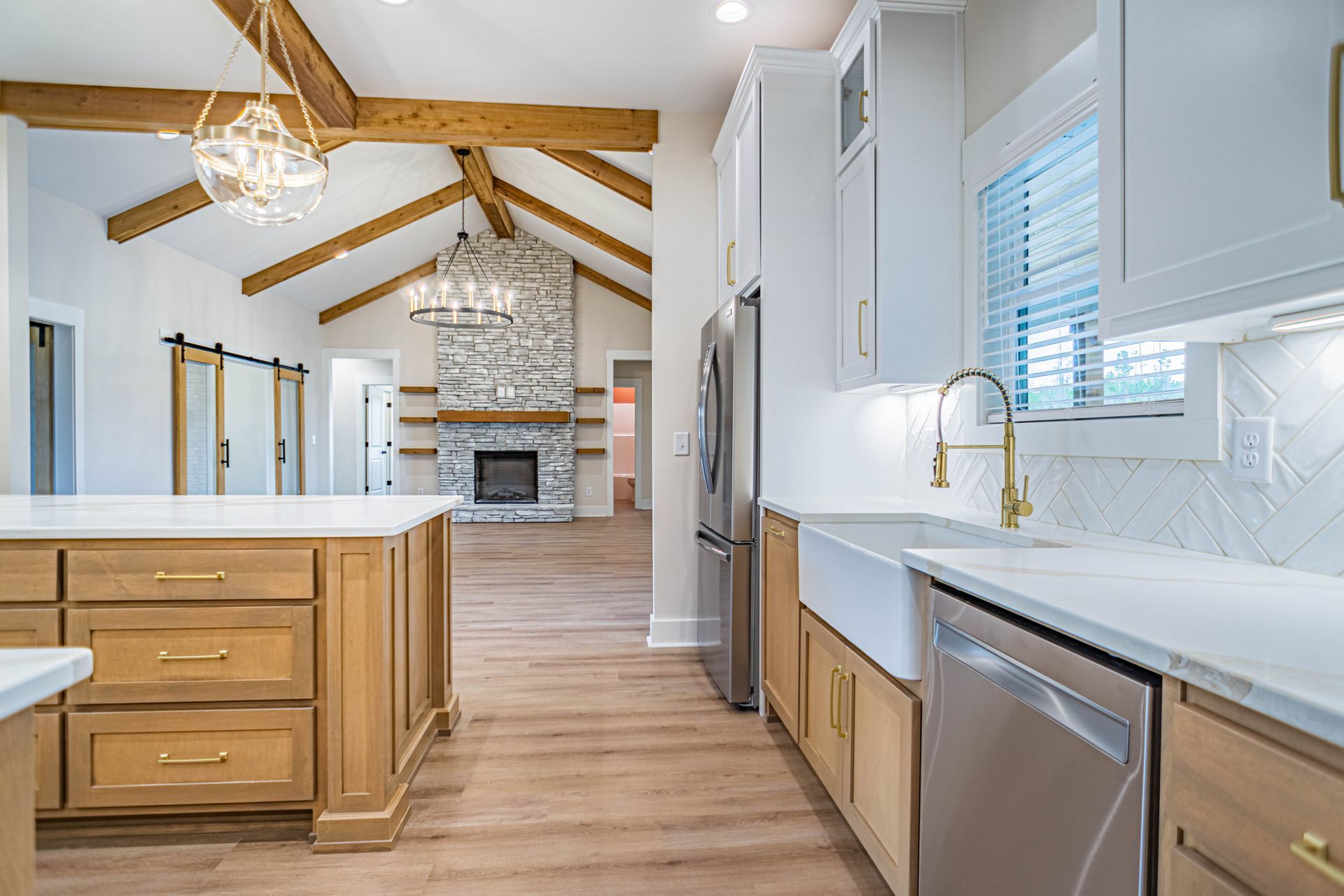 A kitchen with wooden cabinets , stainless steel appliances , and a large island.