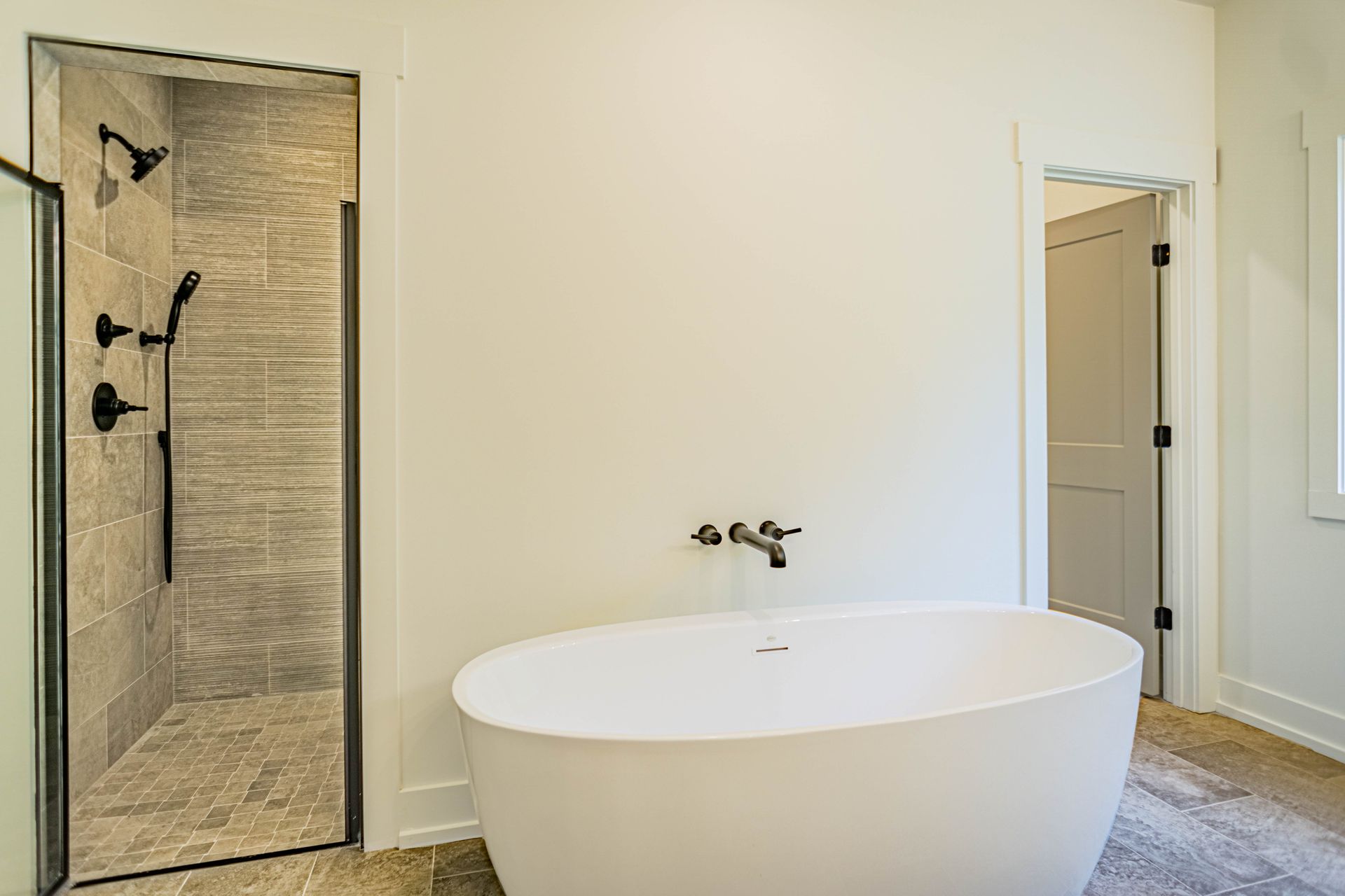 A bathroom with a bathtub and a walk in shower.