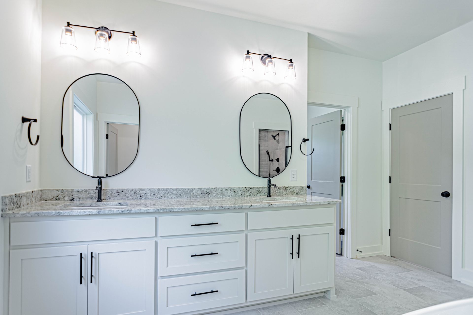 A bathroom with two sinks and two mirrors.