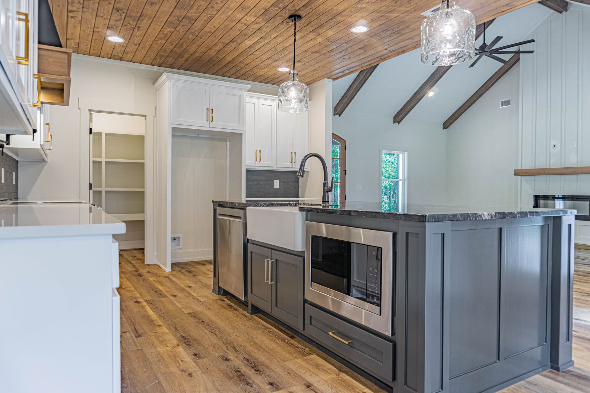 A kitchen with a large island and stainless steel appliances.