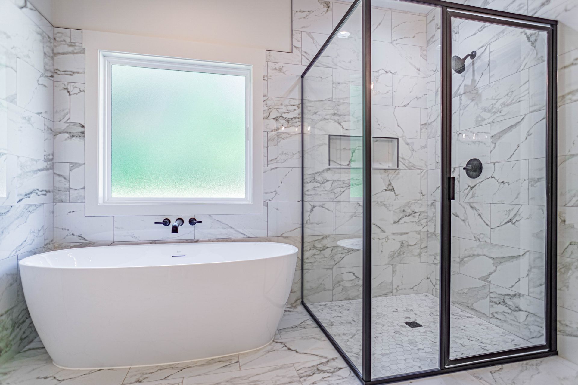 A bathroom with a tub , shower , and window.