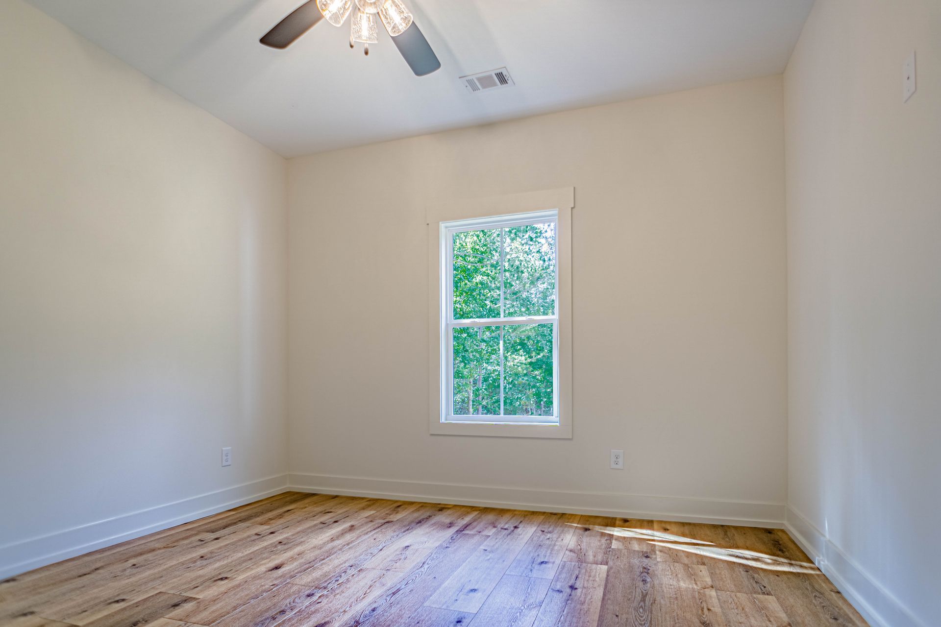 There is a ceiling fan in the room and a window.