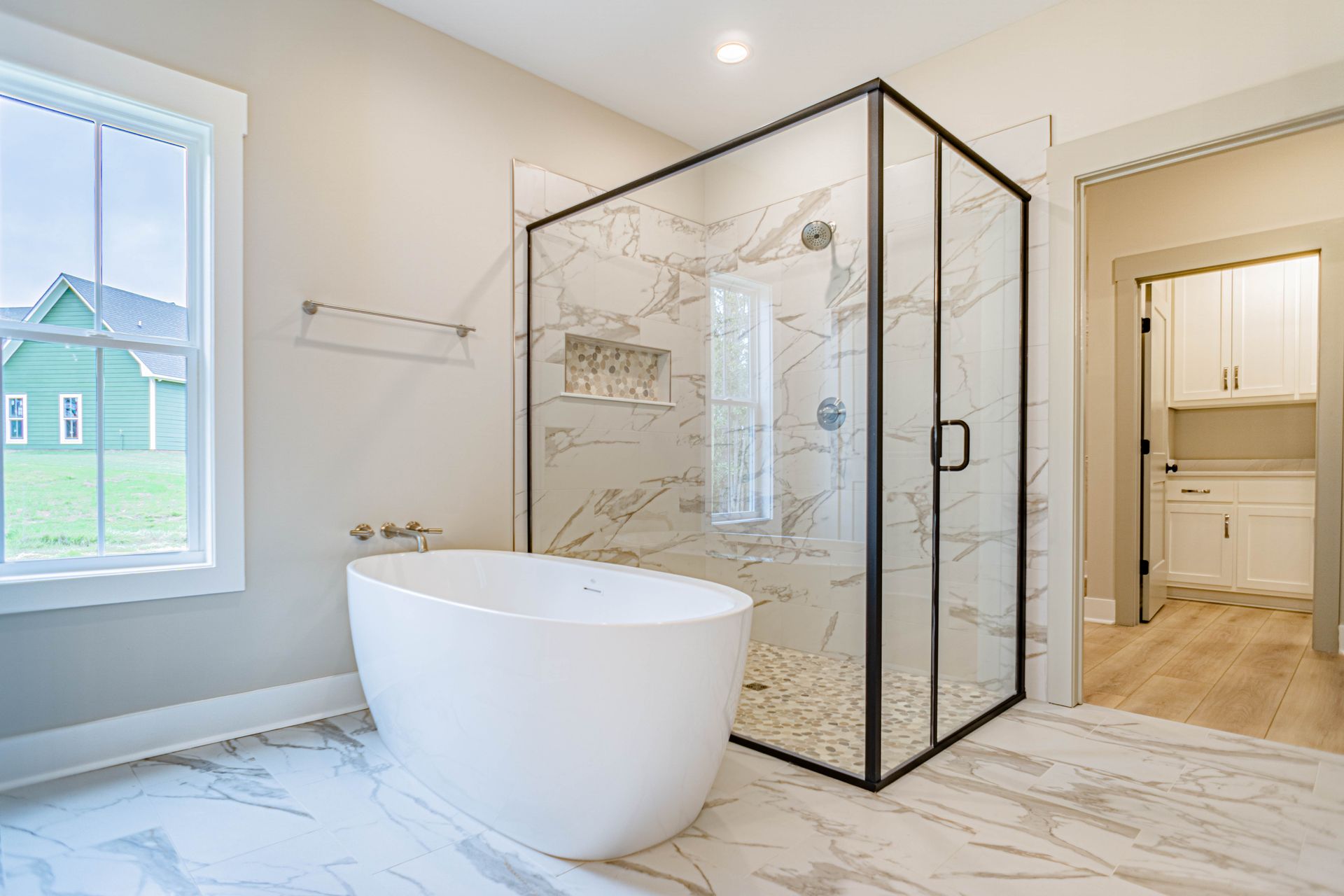 A bathroom with a bathtub and a walk in shower.