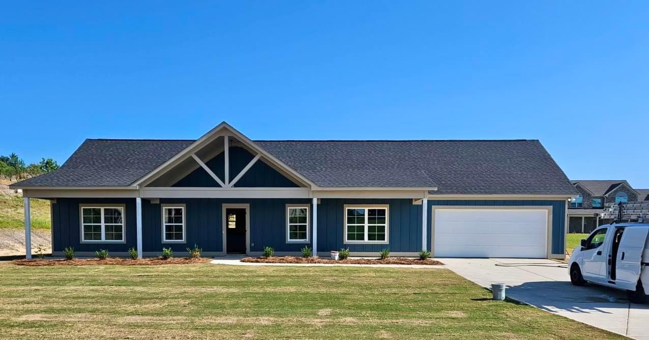 A blue house with a white van parked in front of it.