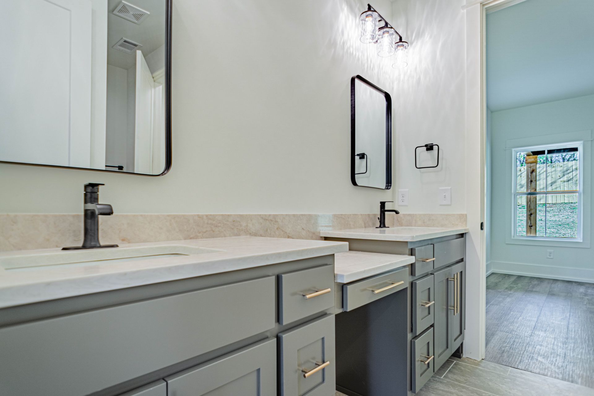 A bathroom with two sinks and a mirror.