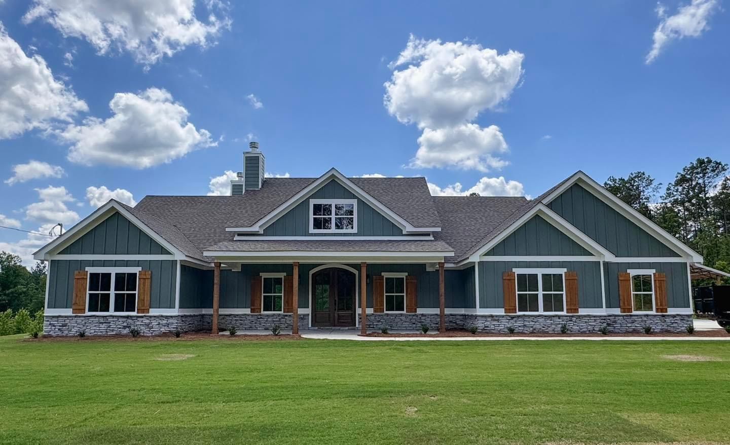 A large house with a lot of windows and shutters