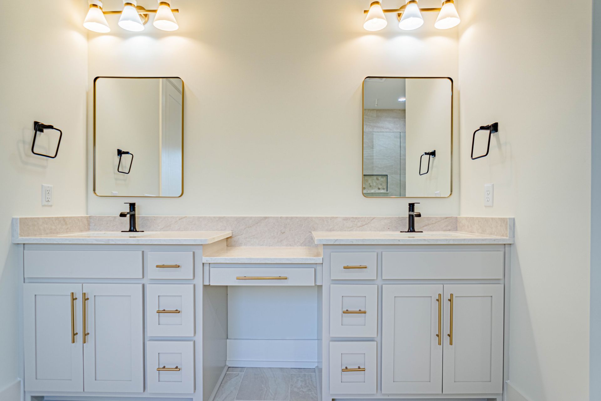 A bathroom with two sinks and two mirrors.