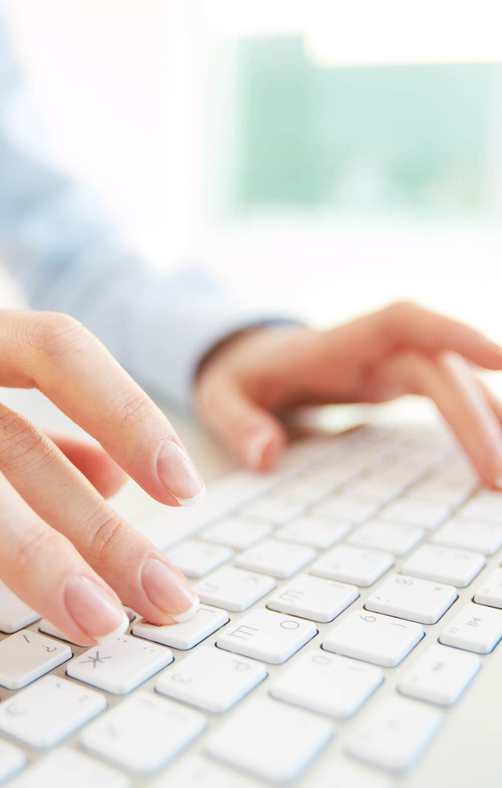 woman typing on white keyboard