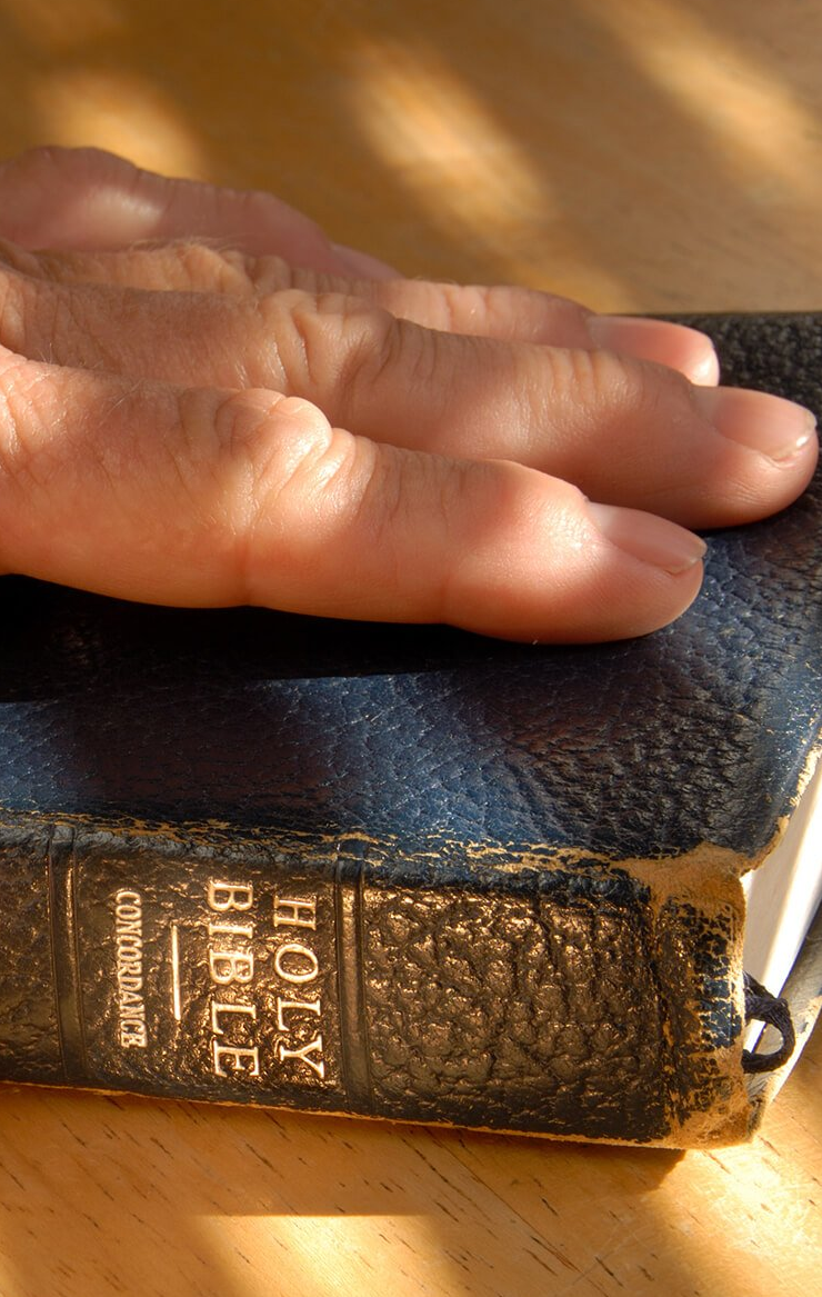 man with his hand on the Bible