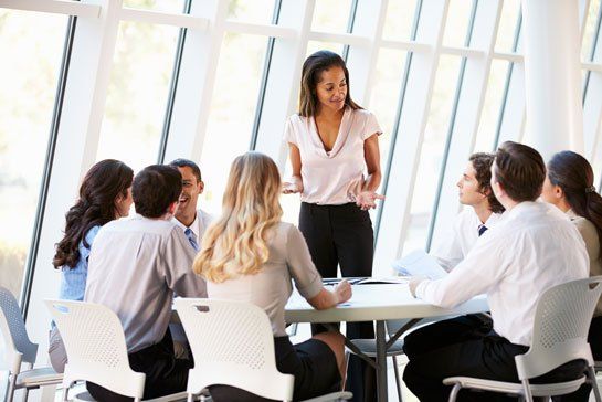woman standing in front of her team