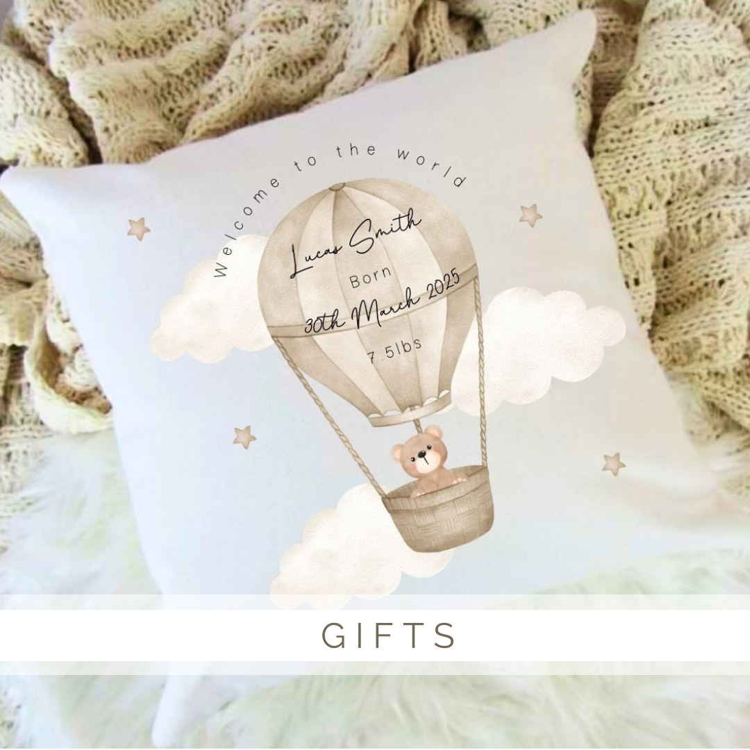 A pillow with a teddy bear in a hot air balloon on it.