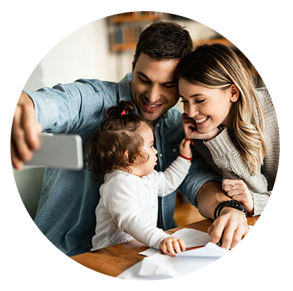 A family is taking a selfie with a cell phone.