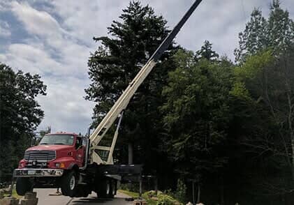 Red Truck Supporting the tree - Tree removal in Gilford, NH