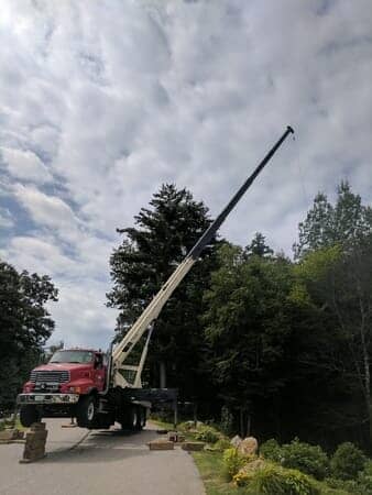 Red Truck Supporting the tree - Tree removal in Gilford, NH
