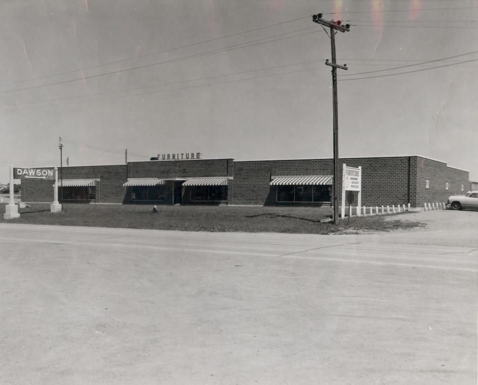 A black and white photo of a furniture store.