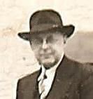 A man in a suit and tie is wearing a hat and glasses.