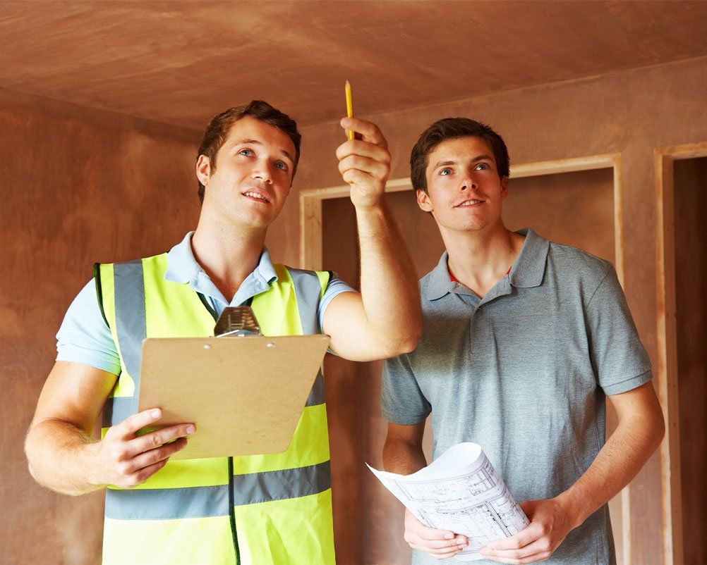 Contractor looking at building project plans with homeowner