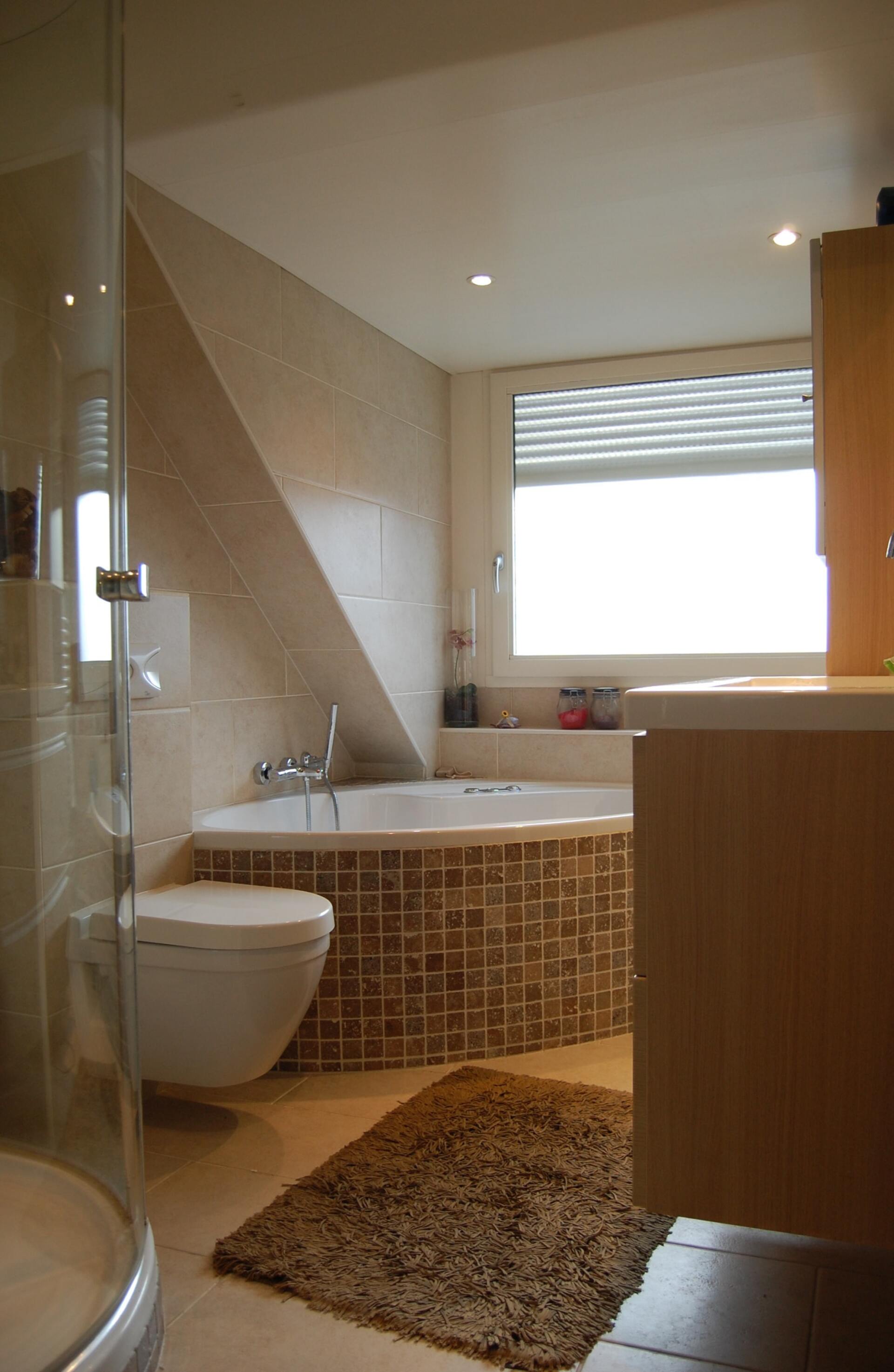 cream and tan bathroom with mosaic tiled corner bath