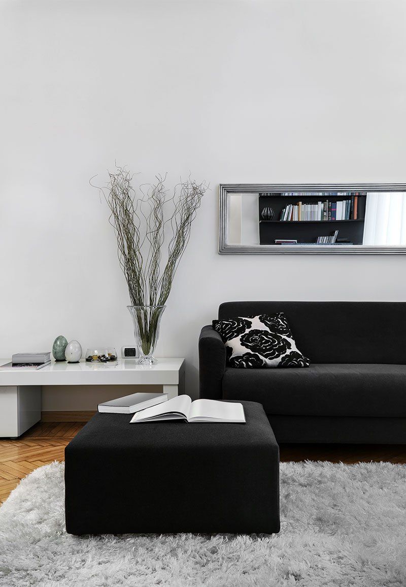 beautiful grey and black refurbished living room with horizontal mirror on wall