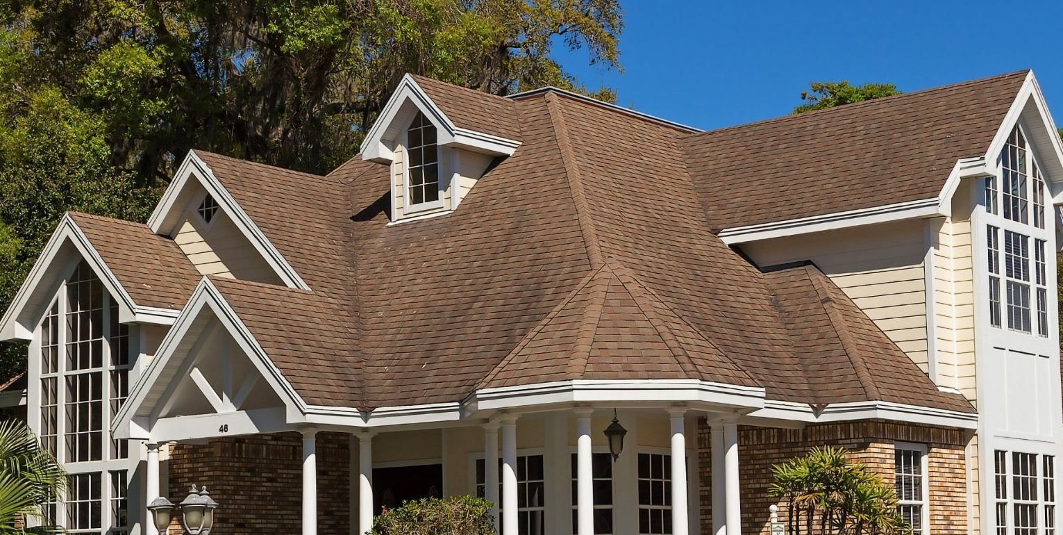 A house with a brand new roof, showcasing the impact of a new roof on home value and resale